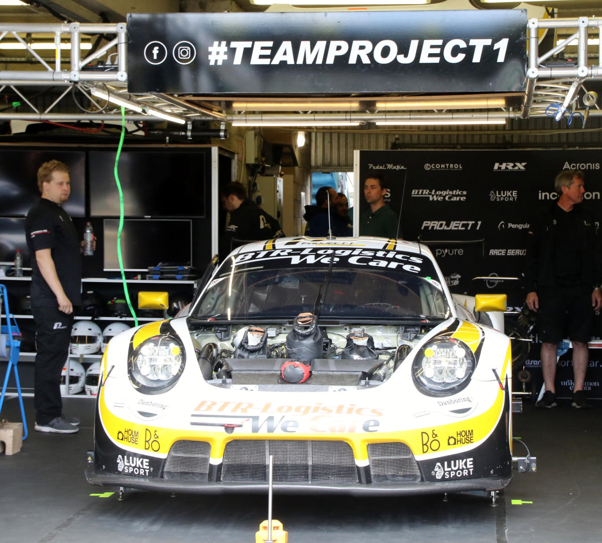 Porsche 911 RSR-19 - Matteo Cairoli, Mikkel Pedersen & Nicolas Leutwiler in the pit garage at the 2022 Le Mans (54279659359).jpg